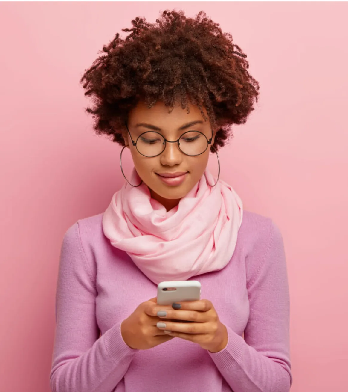 A woman enjoying Bloom Quest Tracker on her phone